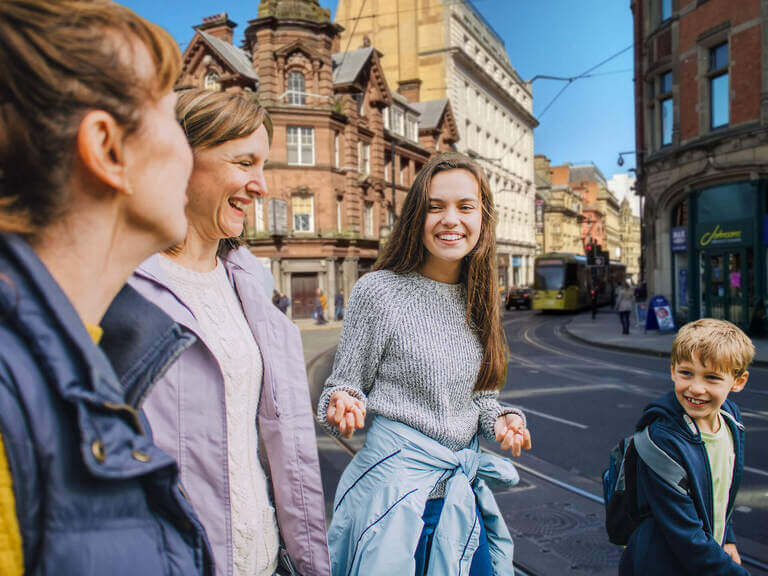 A family walking through the streets of Manchester